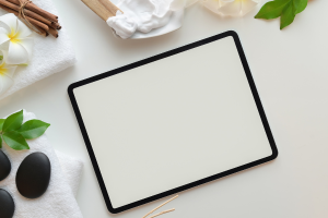 Blank tablet surrounded by relaxing objects.