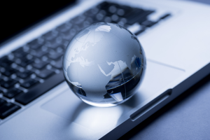 Photograph of a glass globe on a laptop.