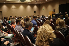 Photo of audience in a nondescript event space.