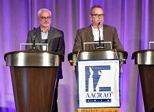 Former AACRAO executive director, Mike Reilly, standing at a podium next to an unidentified male.