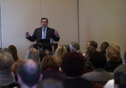 Male speaker addressing an audience.