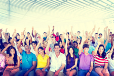 Large group of people all with their right hand held in the air.