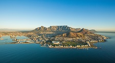 Photo of a land mass surrounded by water with buildings visible on the coast.