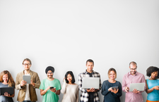 People standing shoulder to shoulder while interacting with their respective devices.