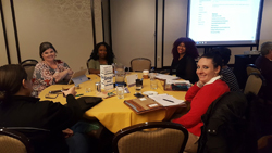 AACRAO members sitting around a circular table at the 2019 Leadership meeting.