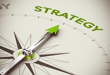 Compass with the needle pointing at the word "strategy."