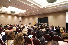 Photo of audience sitting in an event space.